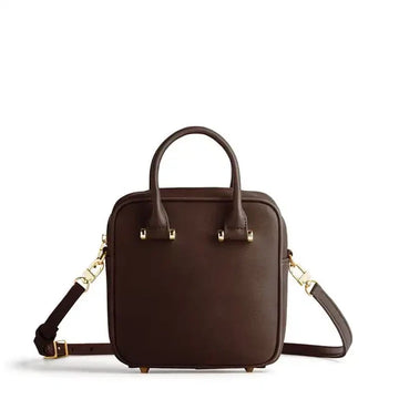 Brown leather handbag with gold accents on a white background