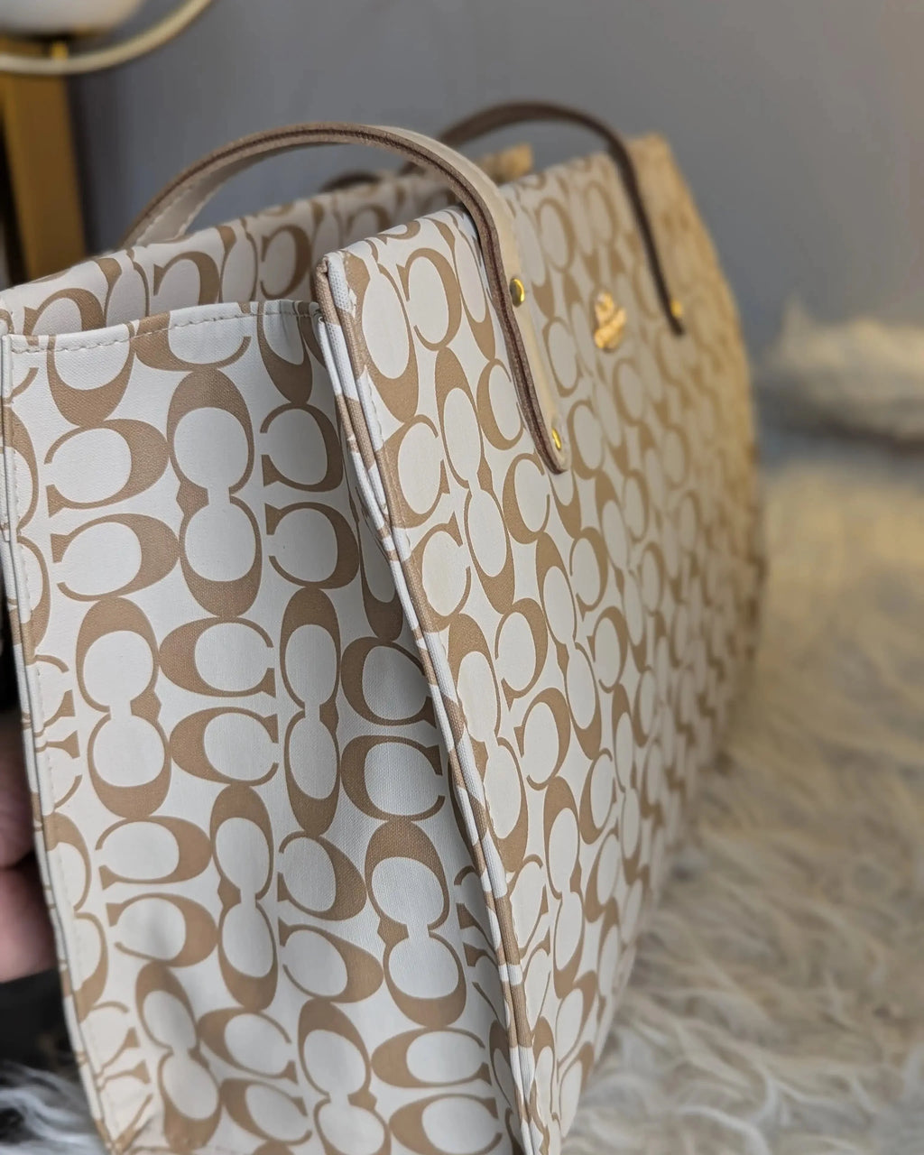Beige handbag with a pattern on a soft surface