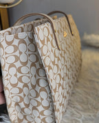 Beige handbag with a pattern on a soft surface