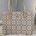 Beige handbag with a pattern on a light gray background