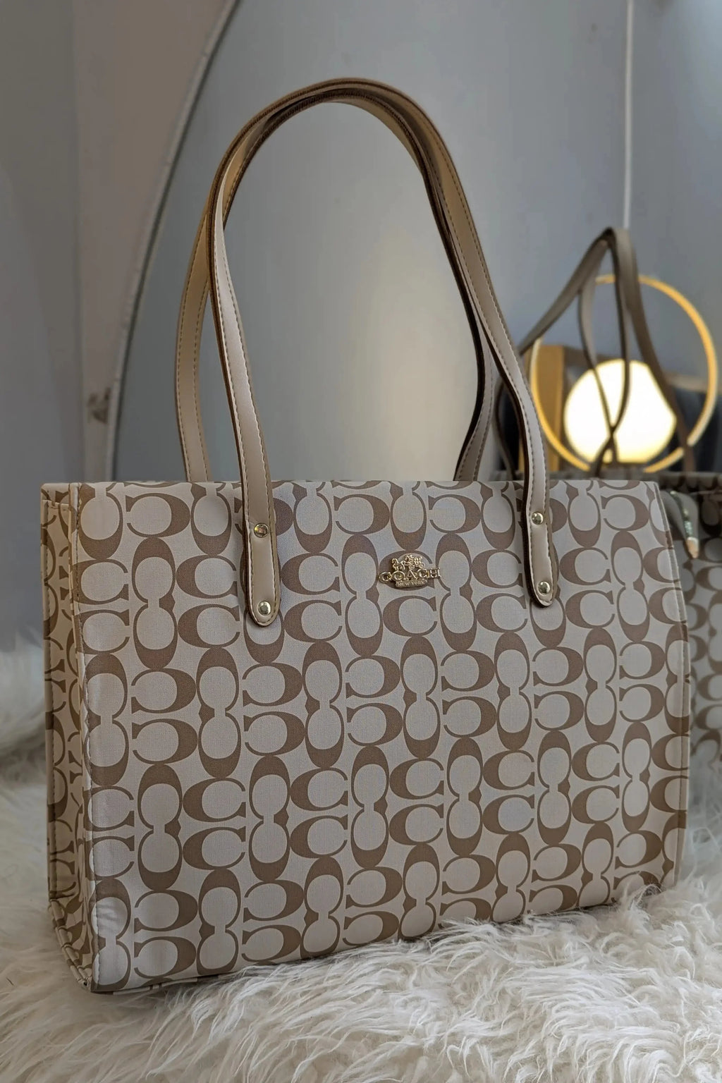 Beige handbag with a pattern on a white surface