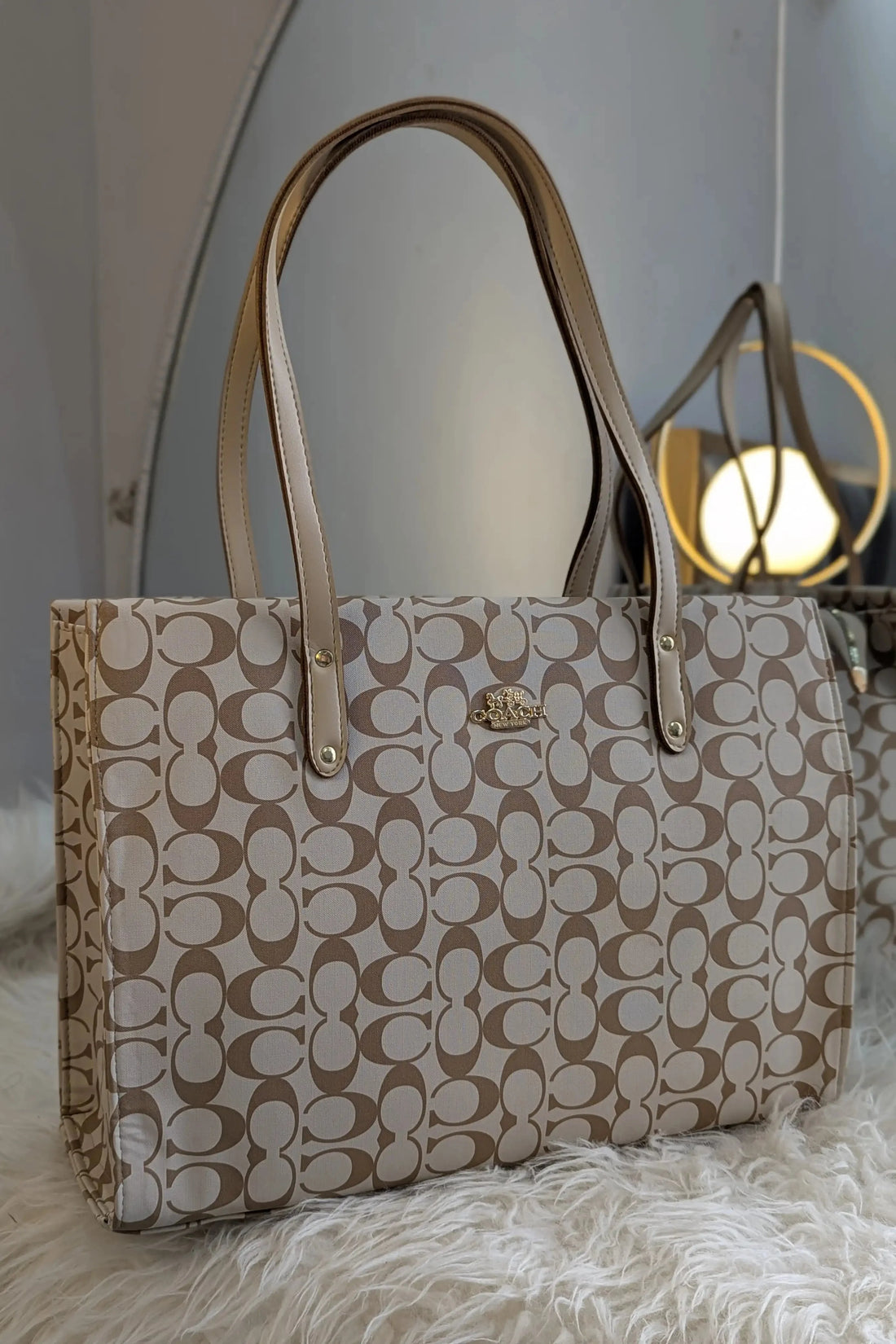 Beige handbag with a pattern on a light gray background