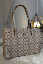 Beige handbag with a pattern on a white surface