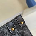 Close-up of a black leather bag with gold studs on a blurred background