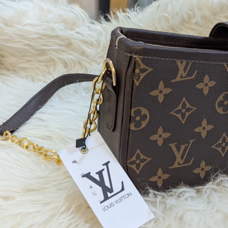 Louis Vuitton handbag with monogram pattern on a fluffy white surface