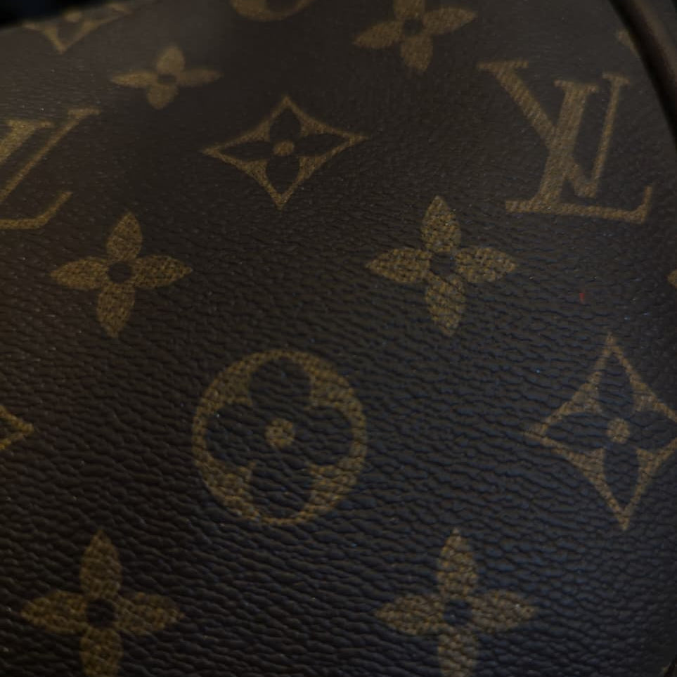 Close-up of a Louis Vuitton monogram pattern on a product.