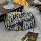 Designer handbag with visible brand logo on a textured surface