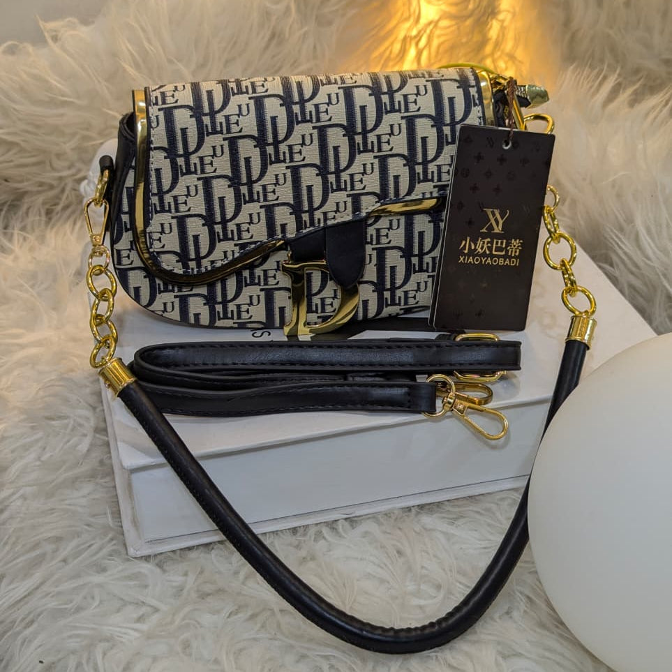 Designer handbag with monogram pattern on a white surface