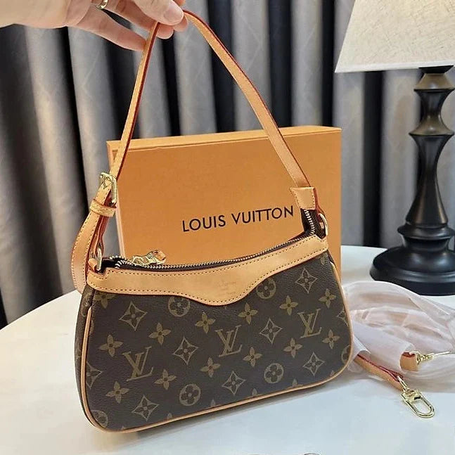 Louis Vuitton handbag with monogram pattern on a white surface