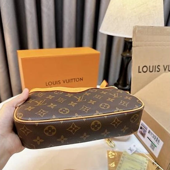 Louis Vuitton handbag with monogram pattern on a white surface